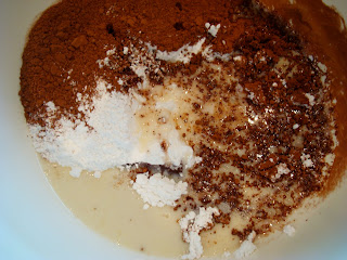 Coconut milk mixture poured over flour mixture in bowl