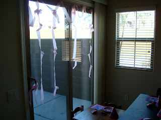 Patio door decorated with pink streamers