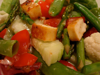 Close up of Sesame Ginger Maple Tofu chopped on top of salad