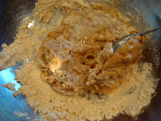 Spoon stirring up No-Bake Vegan Peanut Butter Chocolate Chip Cookie Dough Ball dough