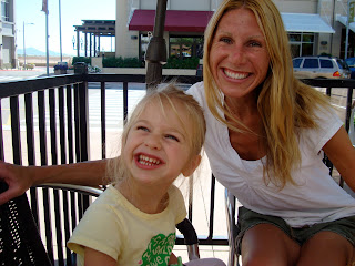 Woman and child sitting in chairs on outdoor patio smiling