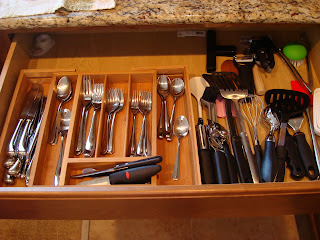 Bamboo expandable silverware drawer organizer in drawer with silverware