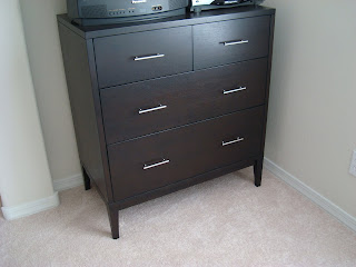 Dark colored dresser showing silver handles