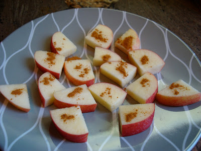 Sliced apple pieces sprinkled with cinnamon