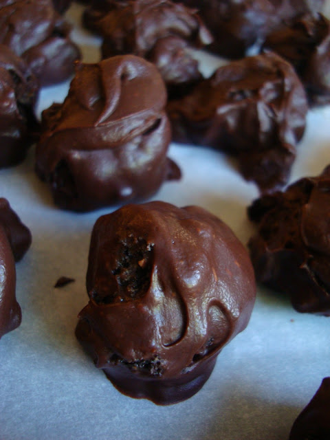 Chocolate Covered Oreo Balls on parchment lined baking sheet