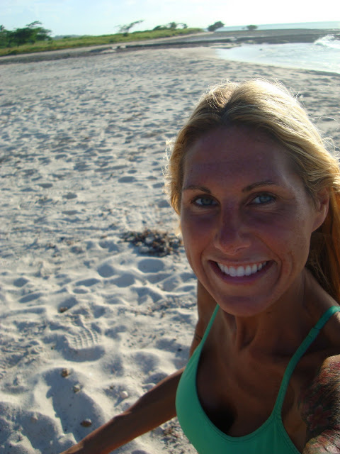 Woman taking photo of self on beach smiling