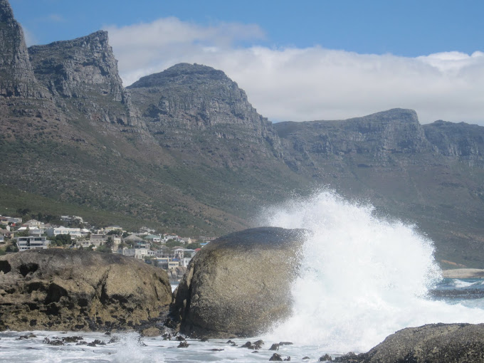 Waves crashing at Camps Bay with Table Mountain and the 12 apostles behind