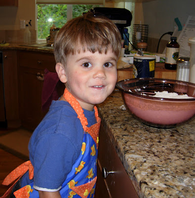 a smiling boy in the kitchen