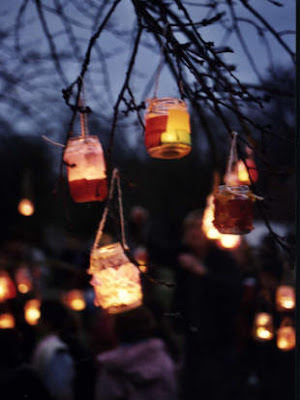 lights jars and lanterns hanging on branches
