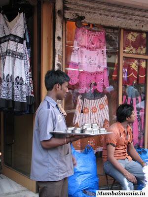 waiter giving tea at shops waiter giving tea at shops