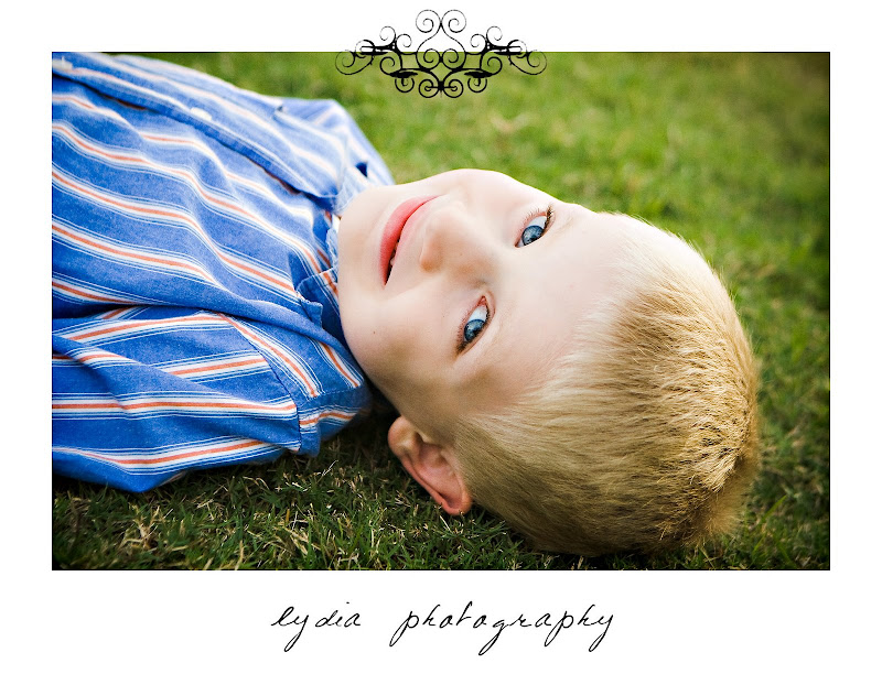 Little boy laying on the grass at lifestyle kids portraits in San Antonio, Texas