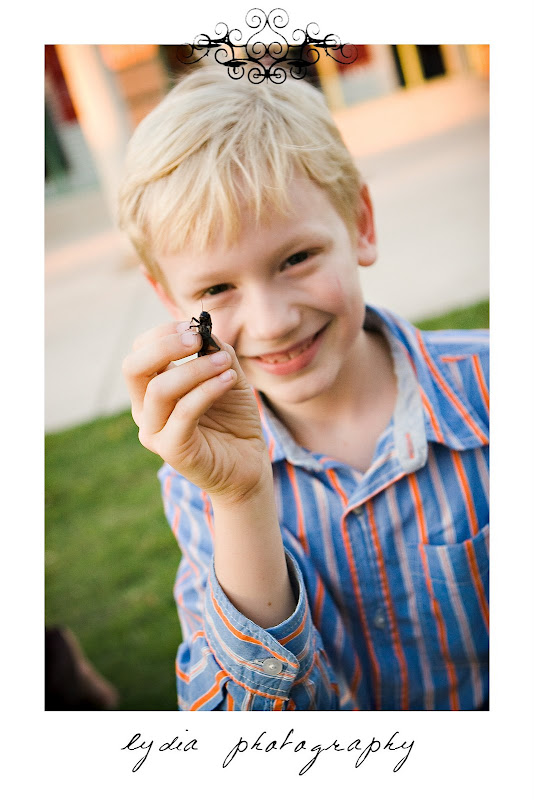 Little boy holding a bug at lifestyle kids portraits in San Antonio, Texas