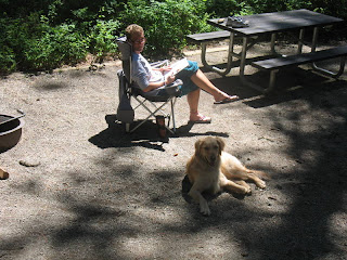 Linda and Kobi in camp reading. Well Kobi doesn't actually read.
