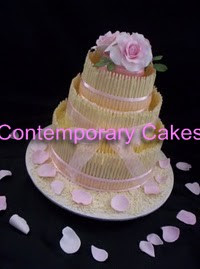 3 tier white chocolate cigarello stacked cake with pink sugar roses.