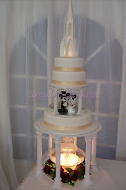 Water fountain gazebo with a illuminated church topper with Mickey and Minnie bridal toppers.