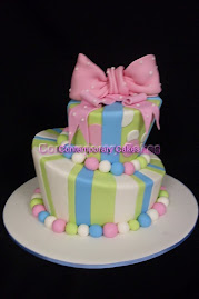 Mad Hatters Cake pastel candy colours and polka dot bow.