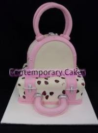A 2 tier  pink and ivory travelling suitcase cake.
