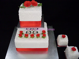 2 tiered pillared cake with 2 miniature cakes.