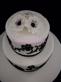 Black and white piped 2 tier stacked wedding cake.
