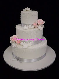 3 tier white stacked sugar blossom and sugar roses with piped details cake.