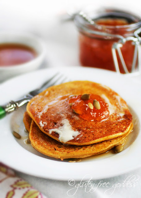 Delicious gluten-free pumpkin pancakes with maple syrup and apricot jam