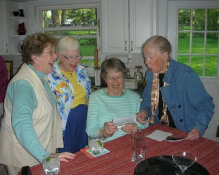 Four of the OCHERs, laughing over photos