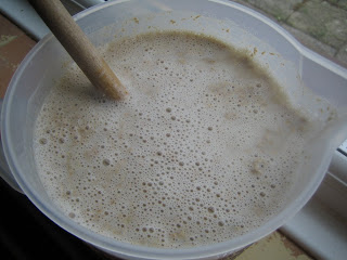 Sourdough starter and warm water in jug