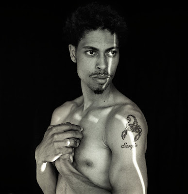 Scorpion tattoo on a black male's upper arm.