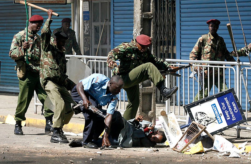 Anti-riot%2Bpolice%2Bbeat%2Bup%2Ba%2BMuslim%2Bdemonstrator%2Bnear%2Ba%2Bmosque%2BNairobi,%2BKenya,%2BFriday%2BPolice%2Bfired%2Bassault%2Brifles%2Btear%2Bgas%2Bat%2Bhundreds%2Bof%2Bpeople%2Bprotesting%2Bagainst%2Bthe%2Bdetention%2Bof%2BJamaican%2Bcleric%2BSheikh%2BAbdullah%2Bal-Faisal.jpg