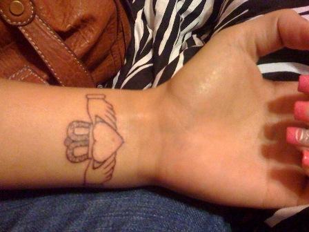 small heart tattoo wrist. Black line heart tattoo on wrist.