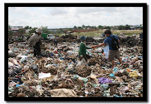 CHILDREN DIGGING and THOUSANDS LIVING IN LANDFILLS FOR BREAD