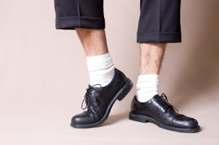 man wearing white socks and dress shoes