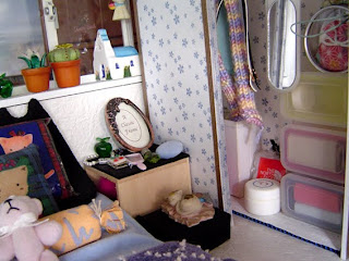 Miniature bedroom with kitten