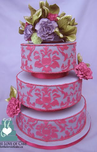 Silk Dress on Three Tier Round Wedding Cake With Pink Damask Pattern Over Light