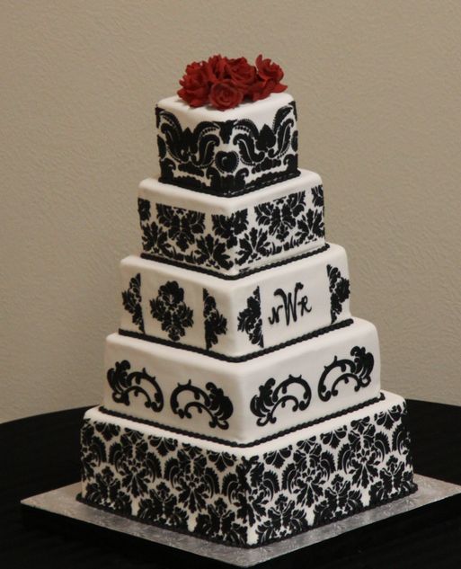 Pure elegance five tier damask pattern wedding cake with red roses on the 