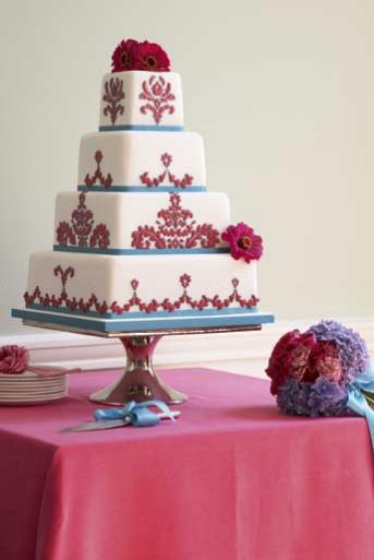 Amazing decadent four tier square wedding cake in reds and gold with damask