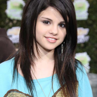 Selena Gomez's curly strands are loosely swept back into an elegant,