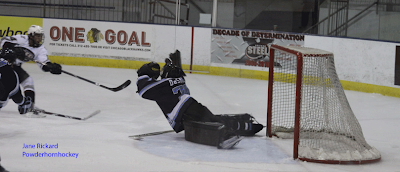 Credit:Powderhornhockey,A worthy effort, Ice goalie Adam Phillips gives his all but lets one by during the second quarter.