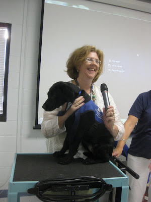 Me laughing with Her Royal Highness on top of a cart and with my arms around her and holding the microphone myself.