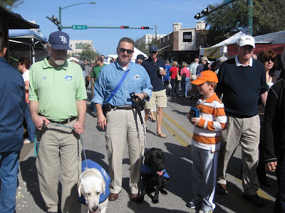 John and Rick and Samuel with their dogs Elvis (black lab) and Dodger (yellow lab).