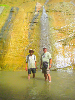 Roland Lee and Jock Whitworth stand by golden wall at Mystery Falls in the Zion Narrows