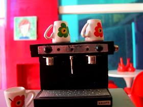 Modern miniature Kaleidoscope doll's house living room view from an espresso machine.