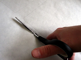 Cutting a piece paper with scissors.