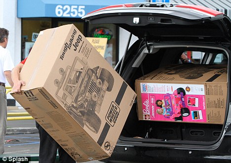 Tight fit: A Toys R Us sales adviser tries to fit the two baby jeeps into Tight fit: A Toys R Us sales adviser tries to fit the two baby jeeps into