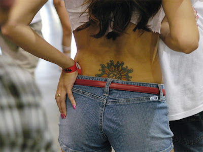 sun tattoo lower back sexy women