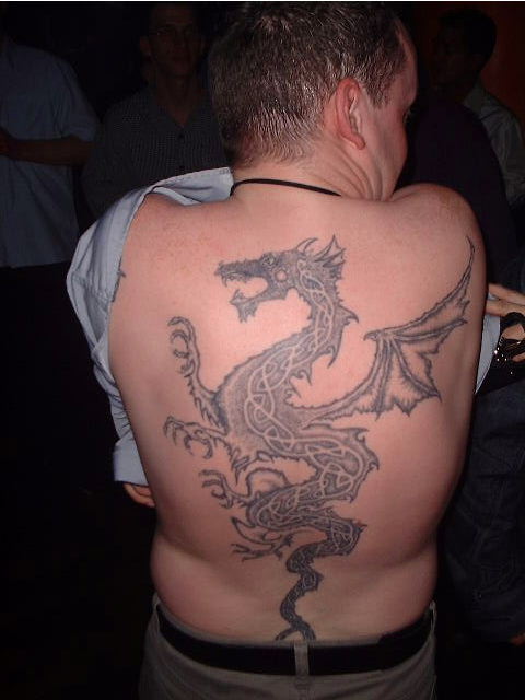 Black ink tattoo covering the entire back. This tattoo required many hours