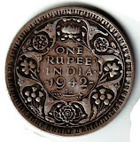 இந்திய நாட்டின் மிகவும் பழமையான ரூபாய் நோட்டுக்களின் படம். 1rupee+coin