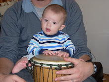 Q-Dawg sitting on my lap playing the Djembe