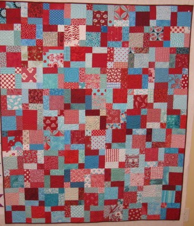 I now have a finish on my Red and Blue Split Nine Patch quilt.