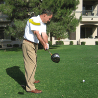 right shoulder turns as arm swings club